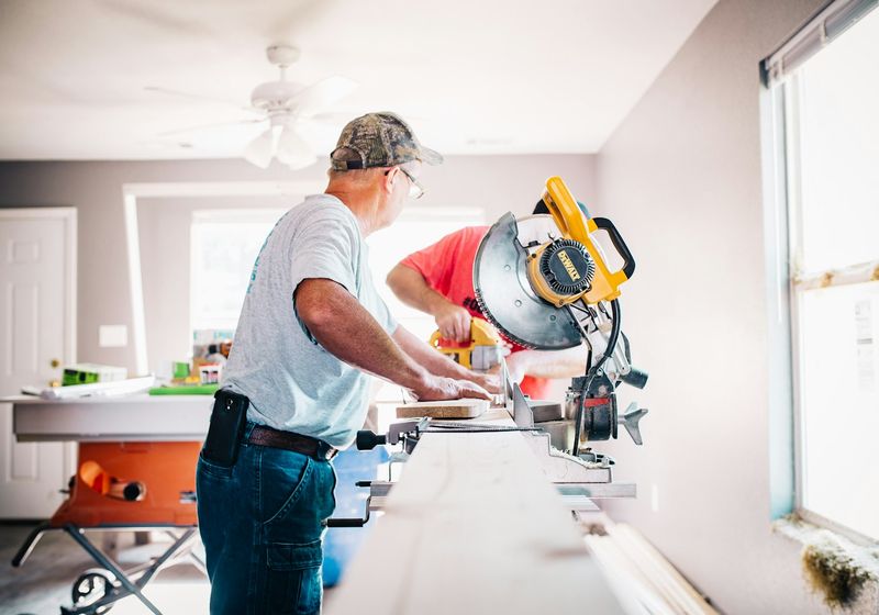 Handyman cutting timber with a mitre saw